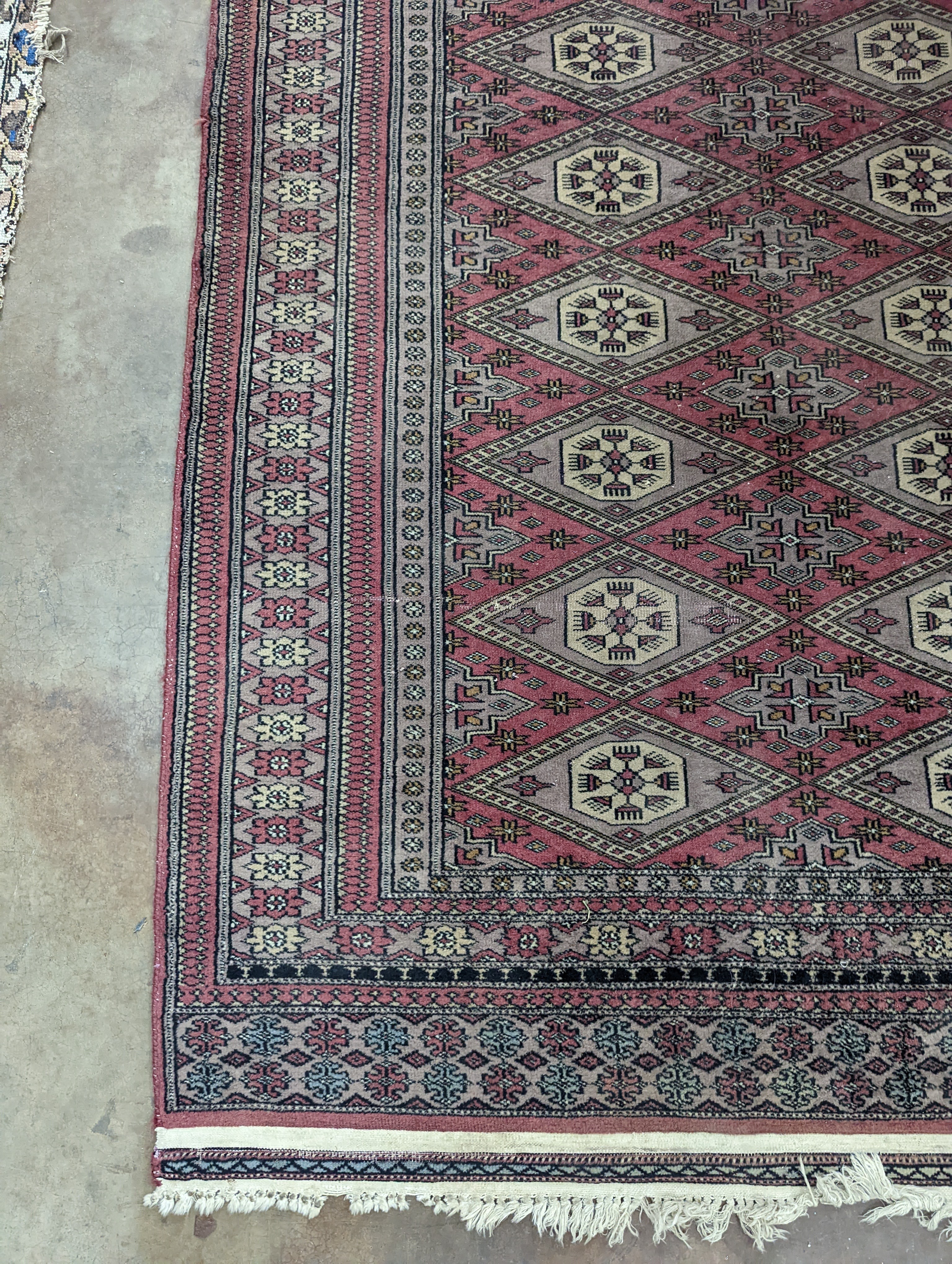 A Tekke Bokhara red ground rug, woven with rows of elephant feet, 180 x 126cm